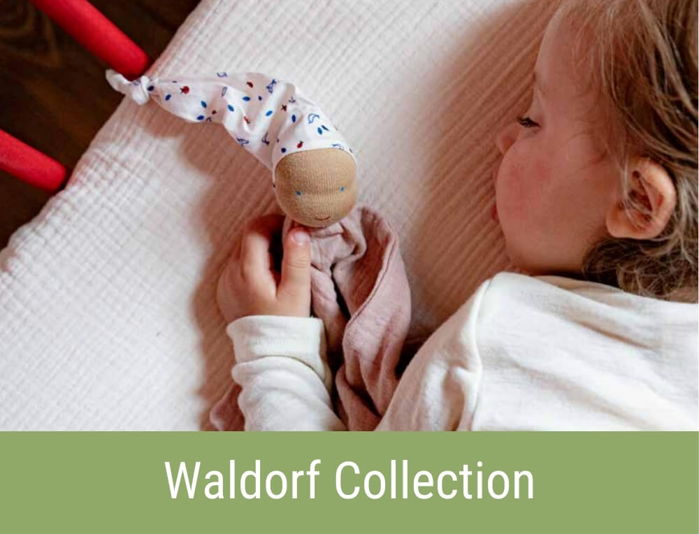 Baby snuggling with handcrafted Kathe Kruse Waldorf comforter toy from Mercurius Australia