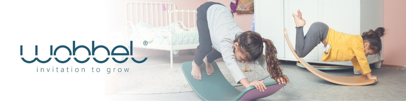 Children balancing and moving on Wobbel wooden balancing boards at Mercurius Australia